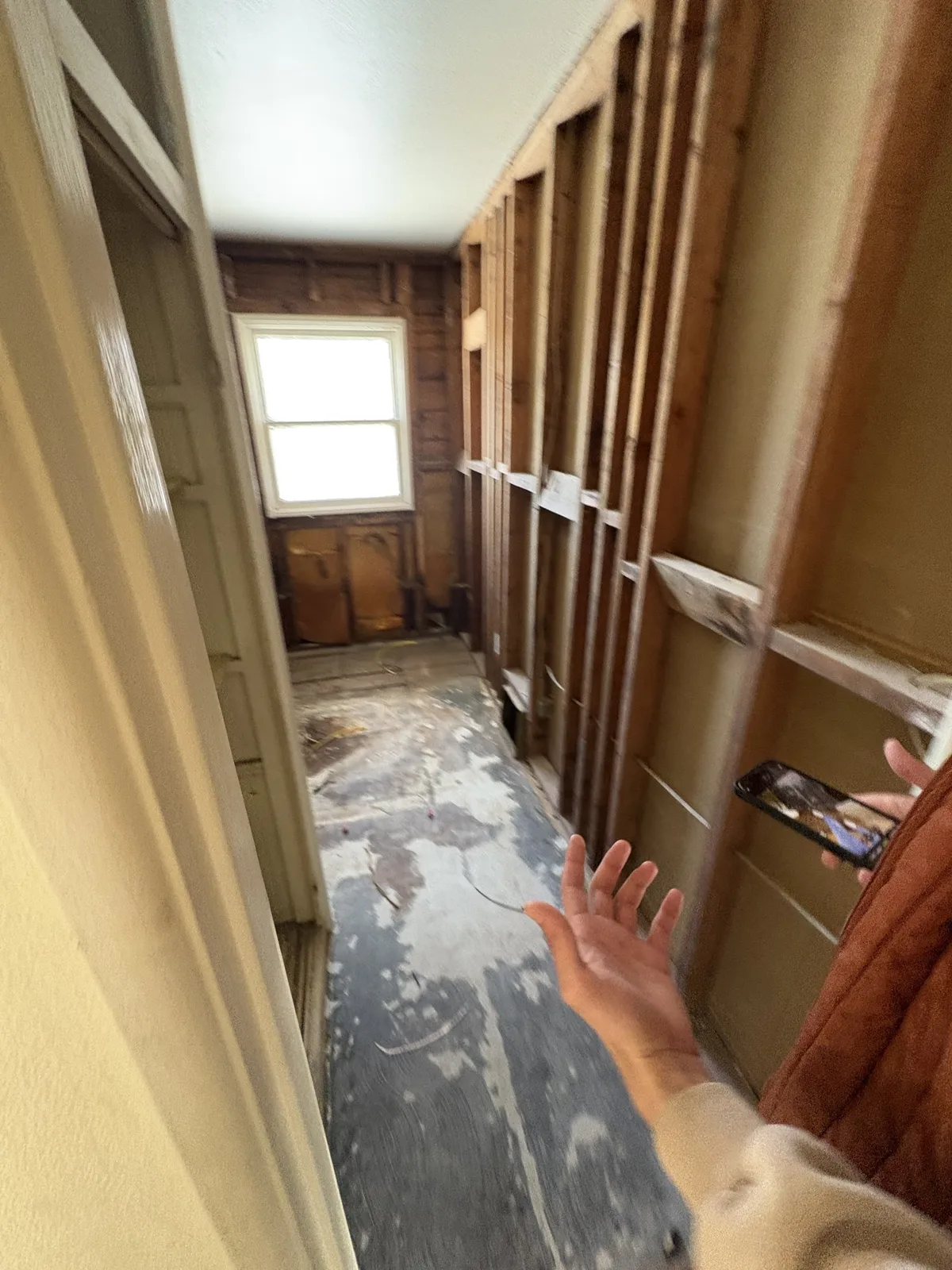 Scottdale bathroom during demolition, with wall framing exposed